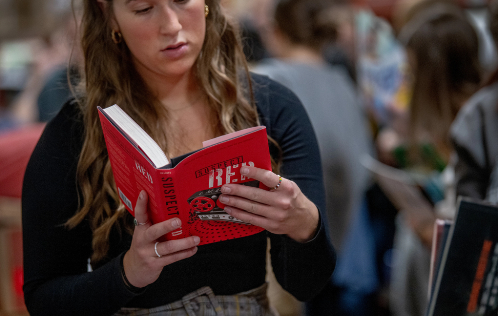a student looking at a book in the Michigan Literacy Program