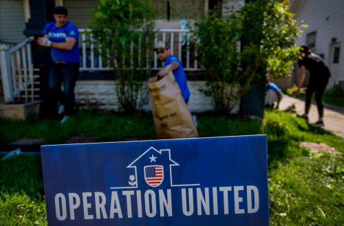 a sign that says operation united in front of a house