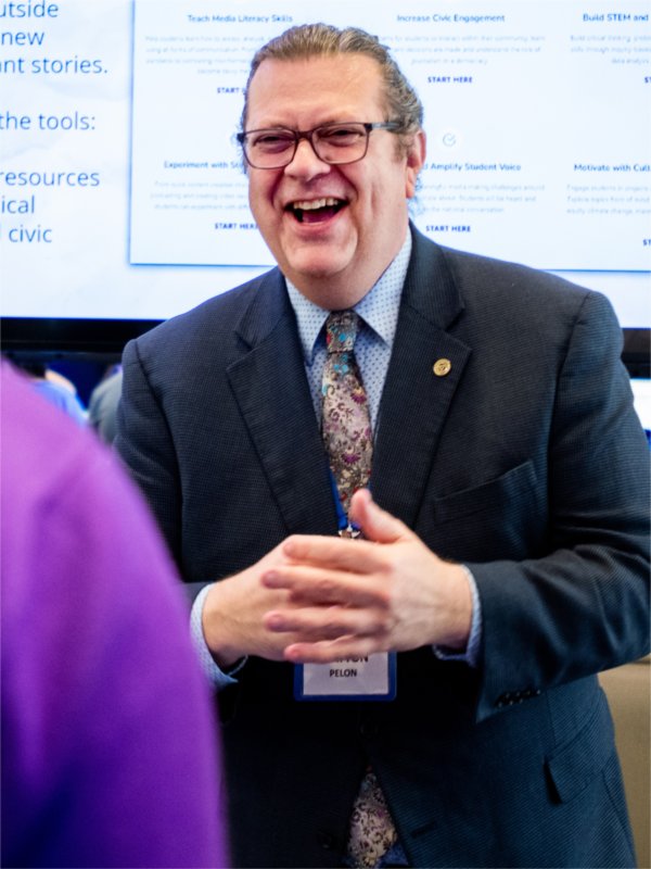 Clayton Pelon, director of Center for Educational Partnerships within the College of Education and Community Innovation, talks with Grand Valley staff during the Reach Higher Celebration April 17.